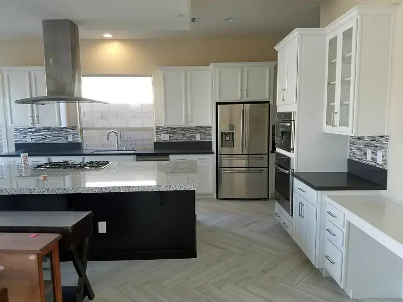 Herringbone tile floor around a kitchen island in a Las Vegas home