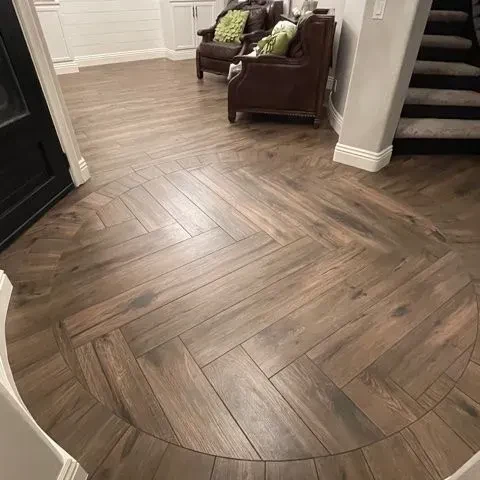 Herringbone tile floor edged with a wood border