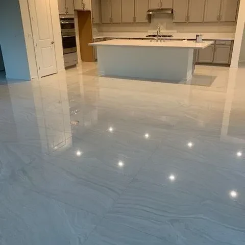 Polished large-format porcelain floor reflecting the room